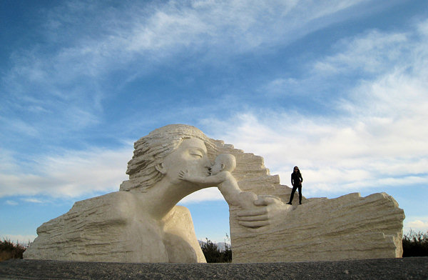 Zhang Yaxi stands on top of her completed monumental sculpture in Qinghai